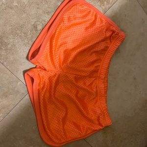 Orange kids shorts. Phrase SCHLITTERBAHN on back
